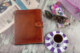  Apple iPad Pro 13-Inch in a BlackBrook leather folio resting on a table with everyday work items.