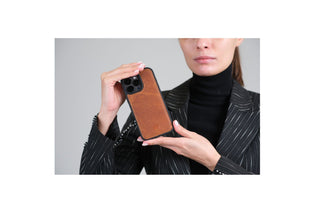  BlackBrook Barlow Leather MagSafe Case in Tan, shown in hand with a metal camera ring.