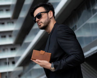Man in a black blazer and sunglasses holding a brown leather folio for Samsung Galaxy S25 Ultra from BlackBrook.