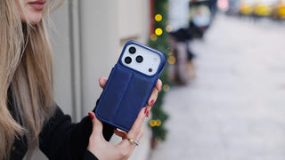A picture of a woman holding her iPhone 17 Pro Max in a BlackBrook case.