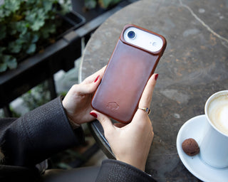 A picture of a woman holding an iPhone 17 Air with BlackBrook’s Mason Snap-On Case.
