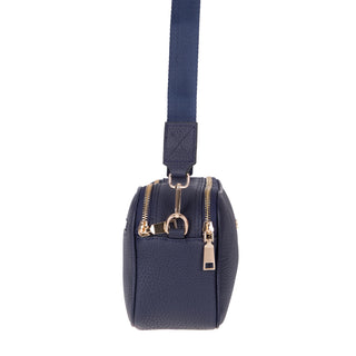 Navy blue handbag with gold zippers on a white background